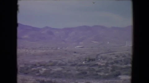 1967: view of an industrial area in vast land with mountain ranges Stock Footage