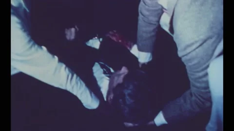 1968 - Aids assist the bleeding, dying RFK on the floor of the Ambassador Hotel Stock Footage 248300470