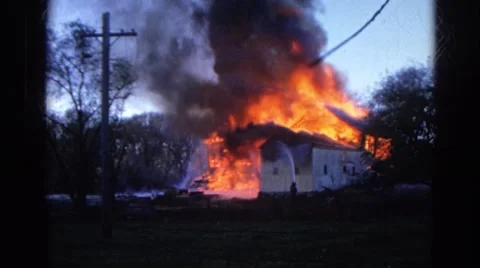 1968: a house engulfed in red hot flames and dark smoke as it burns WAUCONDA Stock Footage