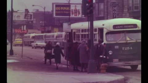 1968 - People get off and board buses on a busy Chicago street. Stock Footage 246305948