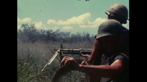 1968 - A US Marine fires a machine gun at the enemy in Danang, Vietnam. Stock Footage 100892460