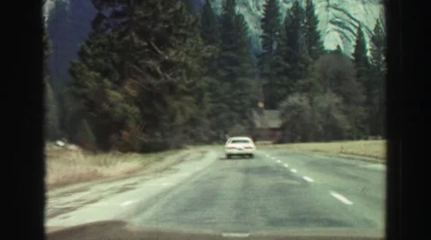 1969: car is moving through the road in the valley of a mountain YOSEMITE, Stock Footage