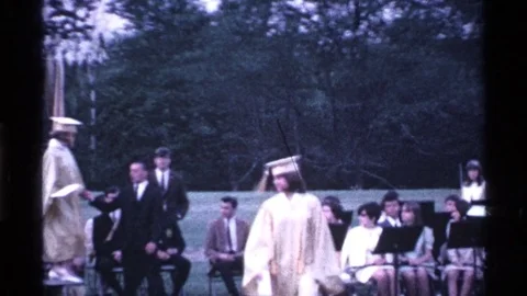 1969: College Convocation Celebration with Students and Floral Decorations in Stock Footage 73566208