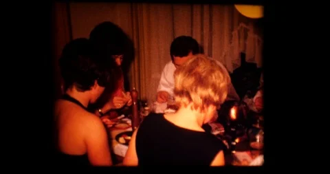 1969 An end of year party Men and women who have fun They talk drink and eat Stock Footage 120260733