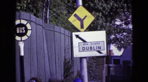 1969: people walking along a street with cars driving to and from dublin Stock Footage