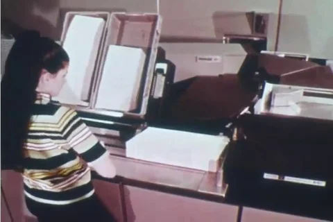 1970 - An optical character reader is used at a postal facility. 動画素材 99669472
