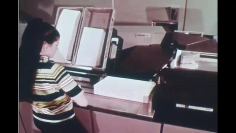 1970 - An optical character reader is used at a postal facility. 動画素材 120038360