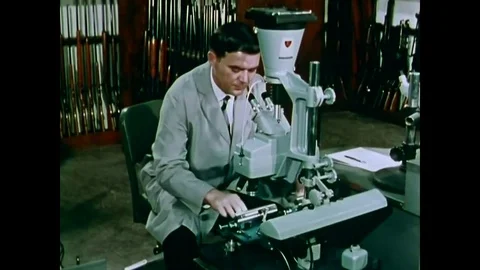 1970 - Under a microscope, striations on a test bullet and evidence bullet are Stock Footage 82999288