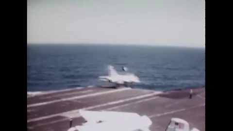 1970 - A US Navy A-7B plane skids overboard on the flight deck of the USS Stock Footage 159147044
