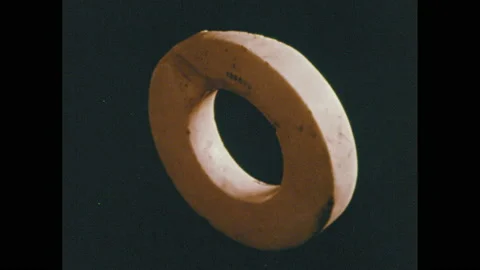 1970s: Ancient objects that were used to barter. Ancient coins. Stock Footage 143982149