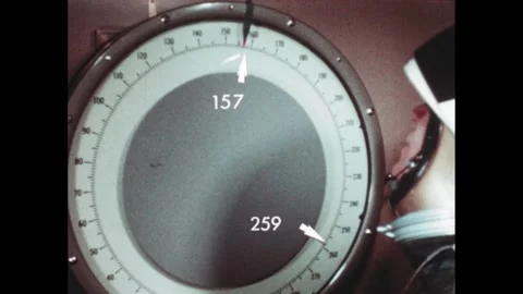 1970s: Arrows and text appear near astronaut and weight scale in elevator. Stock Footage 270368741