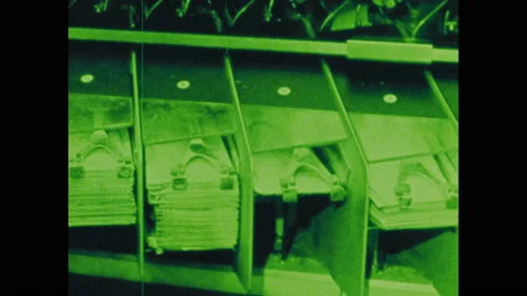 1970s: Bank machine. Rows of numbers. Paper money and coins. 動画素材 143981877