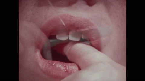 1970s: Boy brushing his teeth. Boy flossing. Boy at the sink rinsing his mouth Stock Footage 228701526
