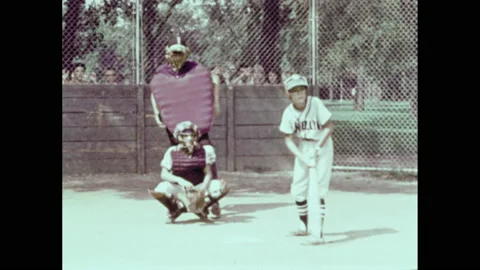 1970s: Boy going up to bat. Multiple boys running up to bat. Boy hitting a ball. Stock Footage 156340521