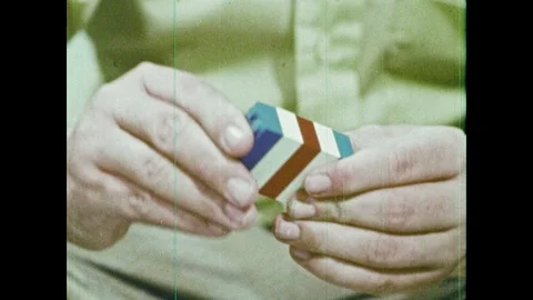 1970s: Boy's hands connect stack of Legos. Boy connects Legos together and Stock Footage 89373763