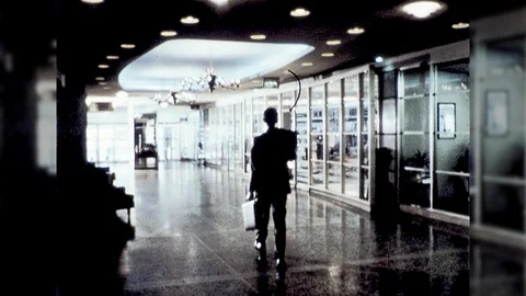1970s Businessman Walks Into Hotel Lobby Business Travel Vintage Old Film Movie Stock Footage