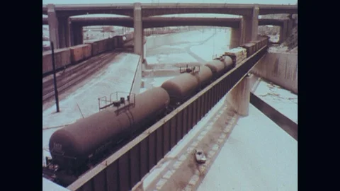 1970s: Car drives down empty water aqueduct as police car gives chase. Car Stock Footage
