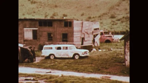 1970s: car exploding in front of run-down wooden building, different parts of Stock Footage 121590344