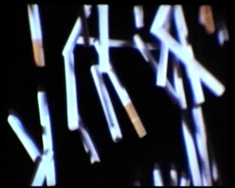 1970s: CIGARETTES FALLING IN SLOW MOTION Video stock 93345266
