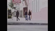 1970S: City.  Young Woman Looks Down Street.  Teenage Girls Put Thumbs Up To Stock Footage