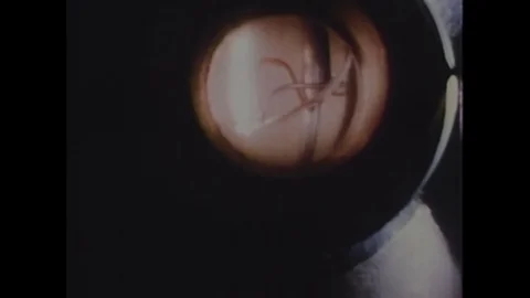 1970s: Close up of rocket ignition / Long shot, man in lab. Stock Footage 74705710