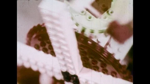 1970s: Close up views of Lego pieces moving, gears turning / Girl with Lego Stock Footage
