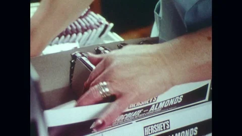 1970s: Close up of woman's hands boxing Hershey's bars. Stock Footage 74921953