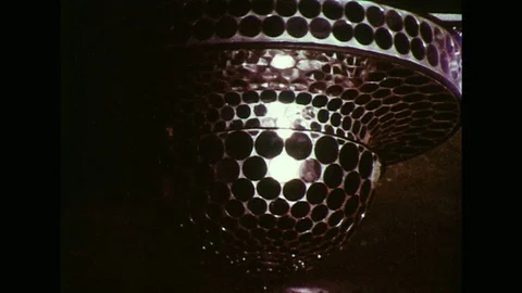 1970s : With the disco ball shining above them, a man and woman slow dance with Stock Footage