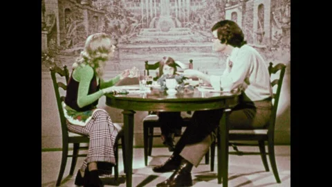 1970s: Family sits at dinner table, parents argue, child watches. Child kneels Stock Footage