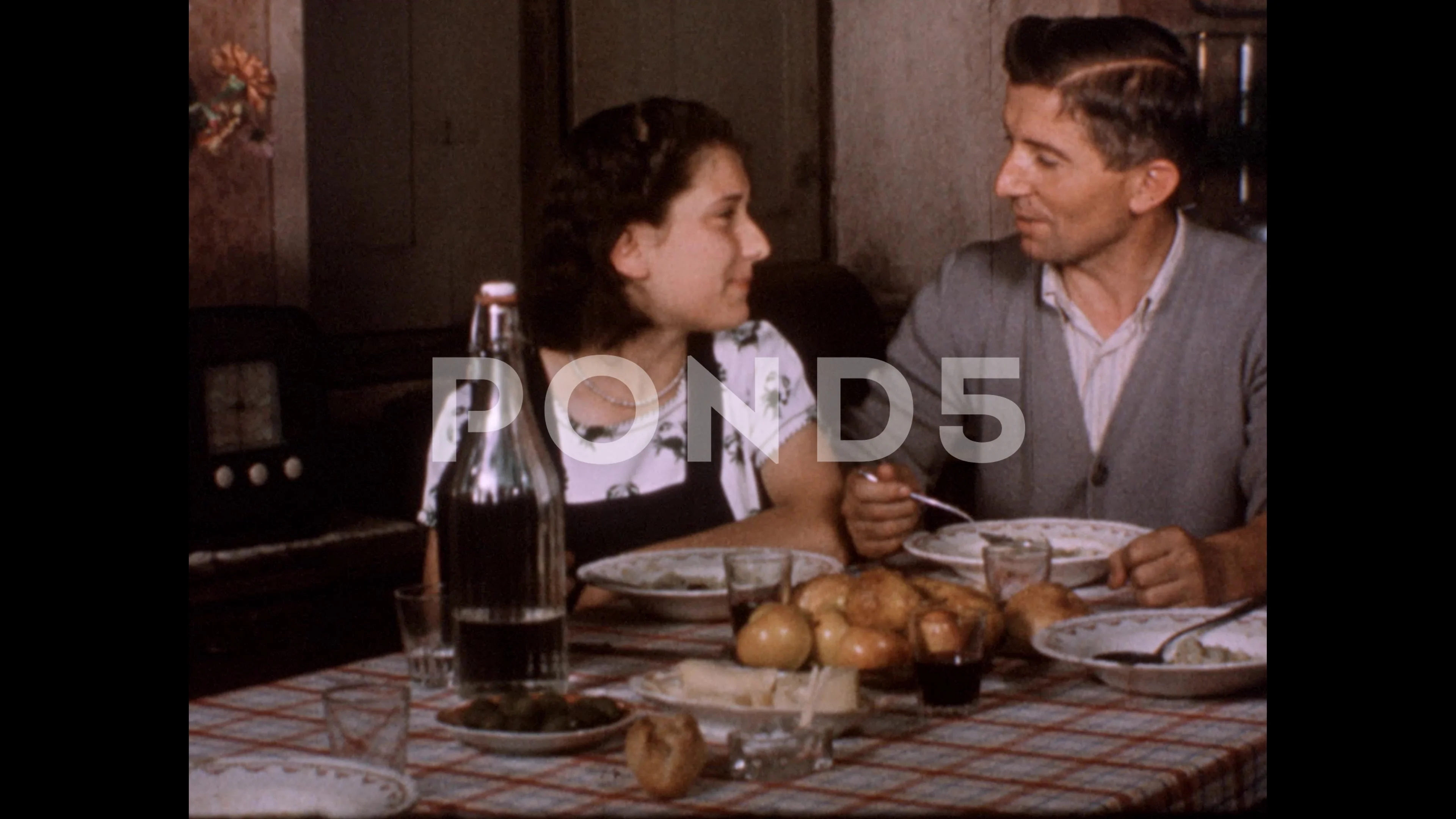 1970s: Father and daughter eat dinner. Daughter turns on radio.