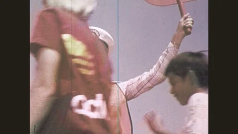 1970s: Female crossing guard helps people cross the street. Female crossing Stock Footage 77242553