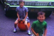 1970S Film Of Children Bouncing On Hippity-Hop Toy On Driveway. Stock Footage