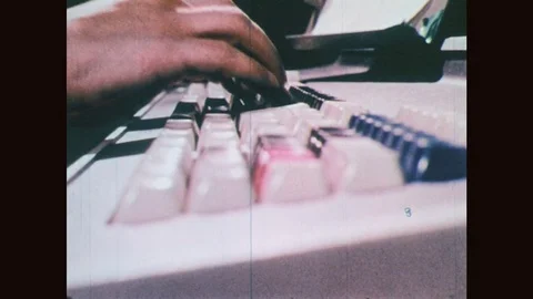 1970s: Fingers typing on keyboards. Woman works on early computer. Stock Footage
