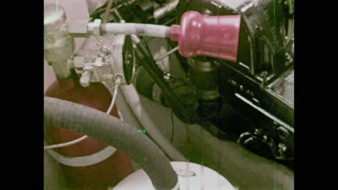 1970s: Fire extinguisher hangs in engine compartment. Man sits on boat and Video stock 169947794