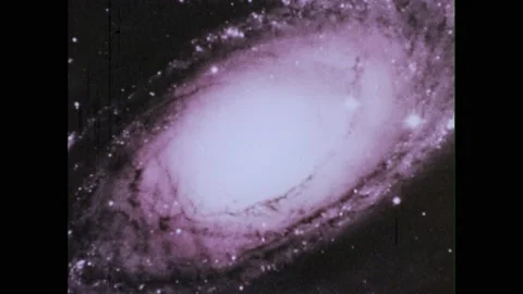1970s: Galaxy in transformation, exploding outwards. Glowing star in the sky. Stock Footage 231417510