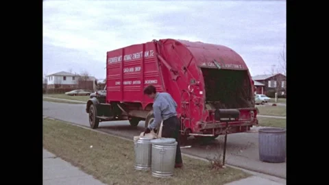 1960s: Trash collector pulls bags from g | Stock Video | Pond5