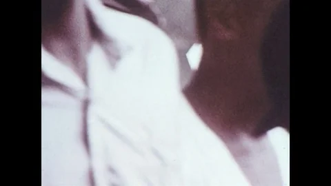 1970s: Group of boys breaks up, walks away / Boy talks to police officers. Stock Footage