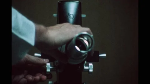 1970s: Hand adjusts focus on projector. Hand covers boy's eye as he reads Stock Footage 192250946