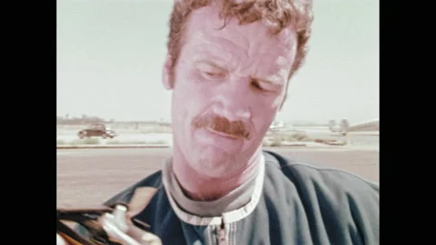 1970s: Hand cranks a meter with red and white dial. Blonde man with mustache in Stock Footage 150352018