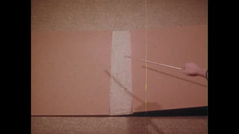 1970s: Hand points with pointer. Axle, wheels roll across different surfaces at Stock Footage 243582122