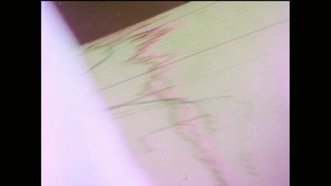 1970s: Hands remove graph print out from machine. Fingers punch buttons on Stock Footage 90349097