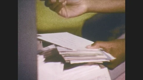 1970s: Hands separate letters and place them in cubicles. Postman walks toward Stock Footage 80065914