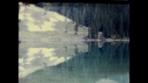 1970s Lake Reflection, Rocky Mountains, British Columbia, Canada 8mm film Stock Footage 333998601