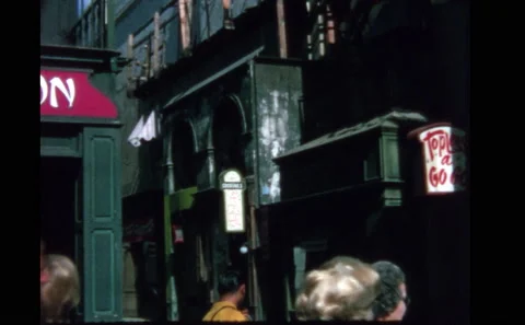1970s LAS VEGAS: Tourists walk through facades and city sets on backlot tour. Stock Footage