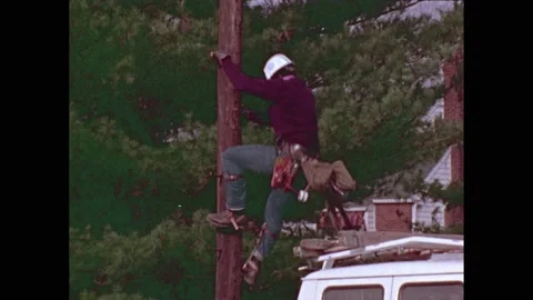 1970s: Lineman climbs down from utility pole. Person picks up telephone. Mailman Stock Footage 232327142