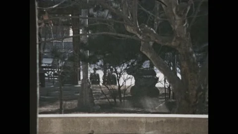 1970s: Looking out window of room, Chinese soldiers stand guard. Inside room, Stock Footage 160844369