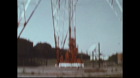 1970s: Low angle tilt up broadcasting tower / Interior of TV studio / Men in Stock Footage 74491211