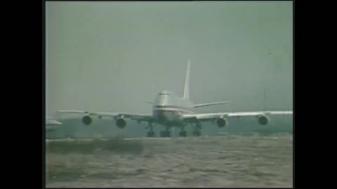 1970s: Low angle view of plane taking off. Flock of geese flying. Plane taking Stock Footage 135841782