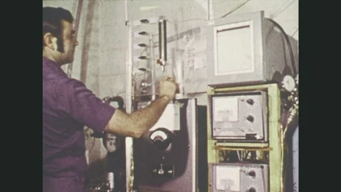 1970s: Man adjusts knobs on machine. Needle on gauge moves. Antelope fawn in 스톡 동영상 86535291