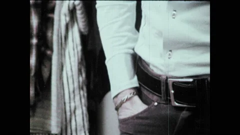 1970s: Man reaches into front pants pocket and pulls out empty hand. Man pulls Stock Footage